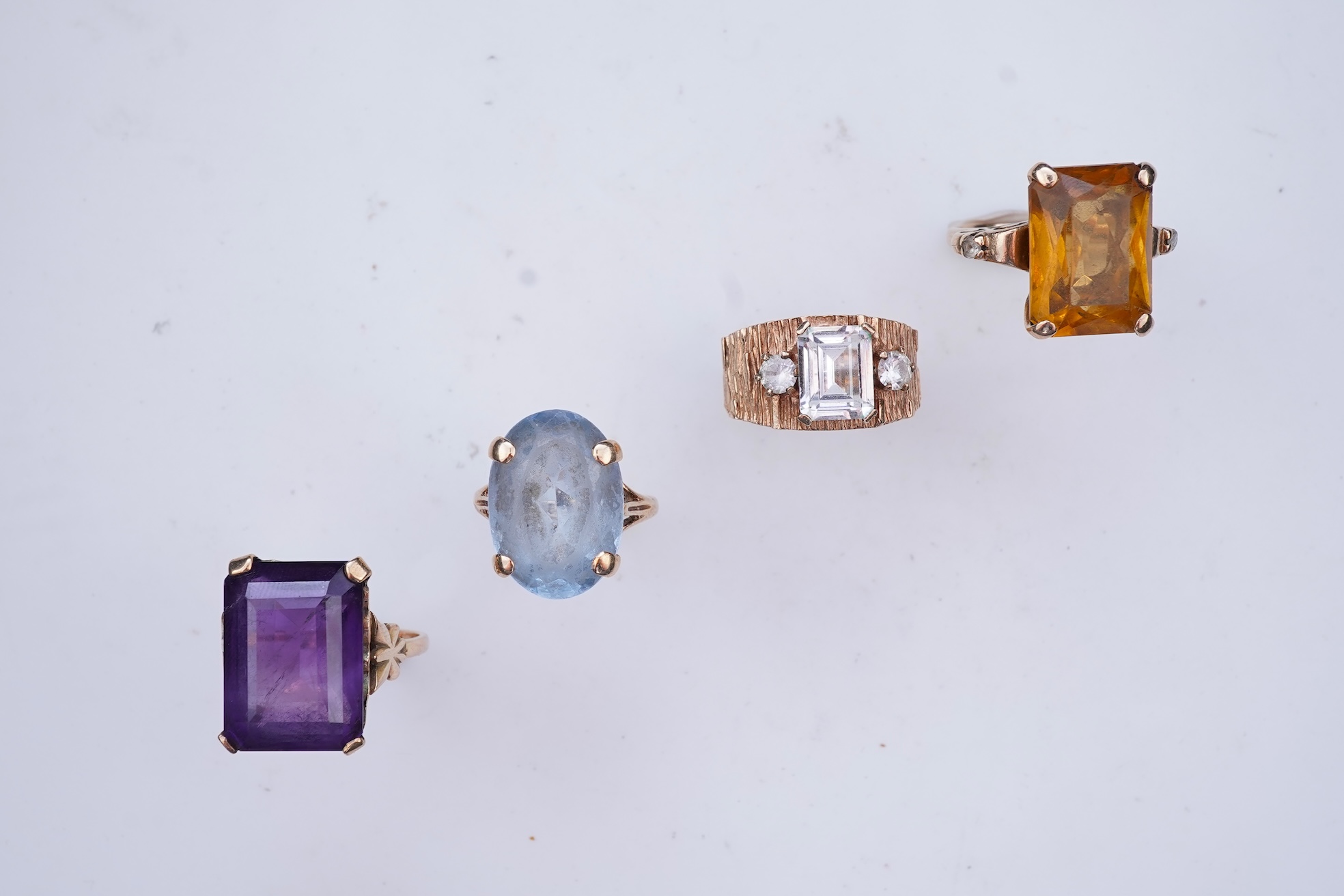 Four gem-set rings